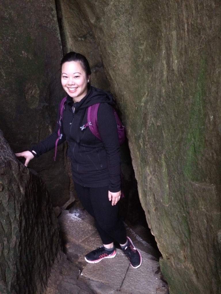 Walking through some stairs behind a boulder