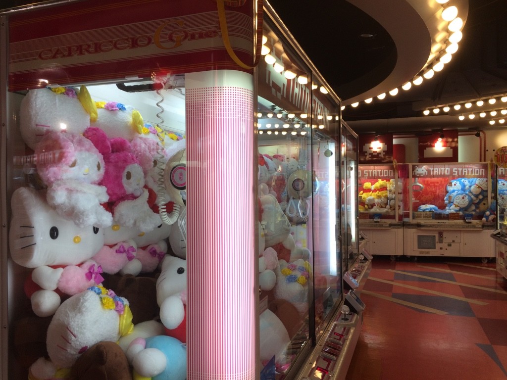 Taito Arcade - there are so many of these machines with toys and even food inside. There are a lot of people playing them and actually winning (Apparently it's a lot easier to win these games in Japan than in NA). Each play is 100 JPY