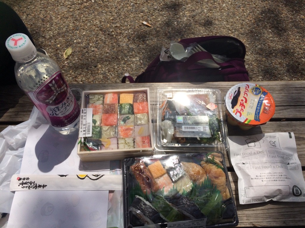 Carbonated grape drink from Family Mart, Tim's battera bento, Family Mart daikon, seaweed and okra salad, Glico pudding, my sushi combo and the Family Mart chicken