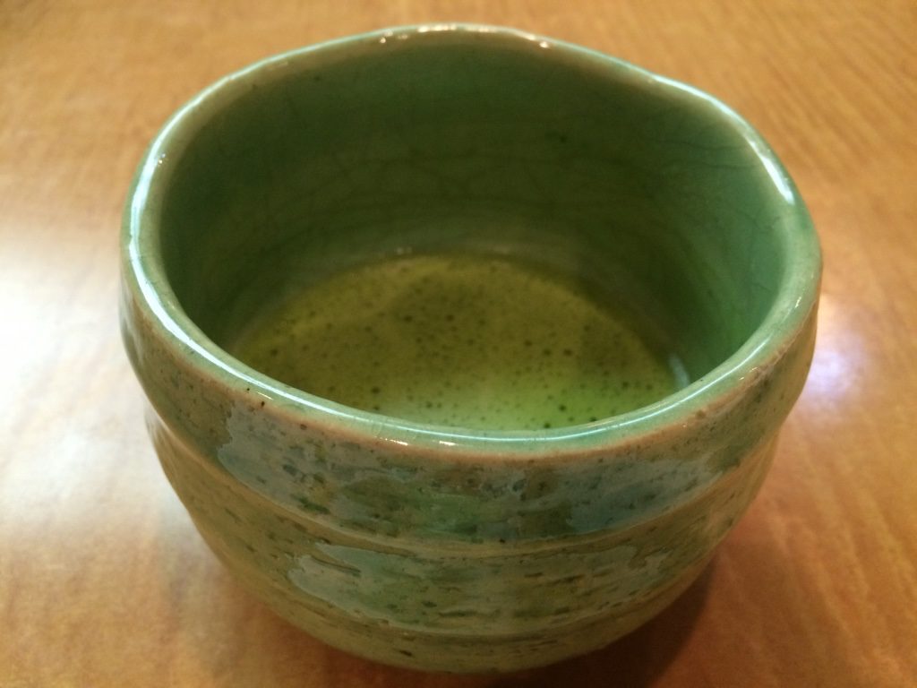 Hot matcha served with dessert. Very strong and not sweetened.