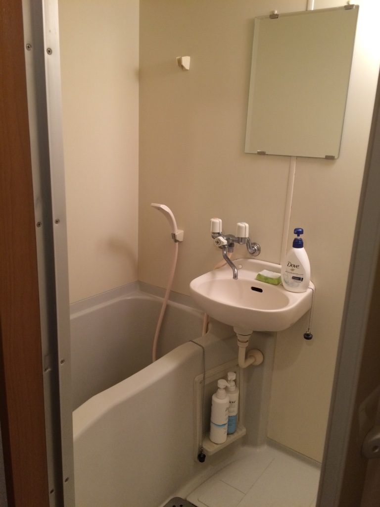 Shower and sink are together. Whole floor gets wet when you shower because there's no shower curtain.