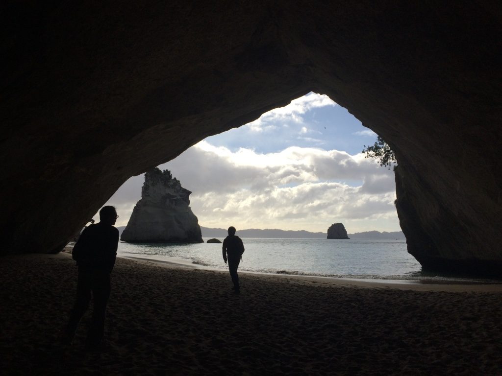Robin and Tim's silhouettes while walking under Cathedral Cove