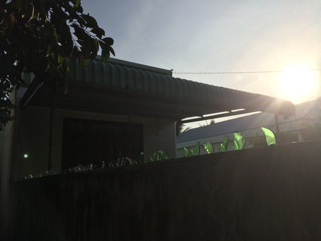 The rice noodle factory had barbed wire and broken glass around their property to protect against thieves