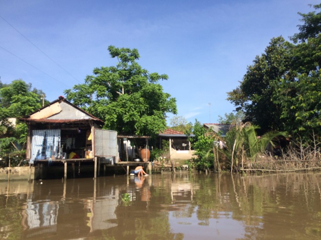 Man doing his laundry in the Mekong