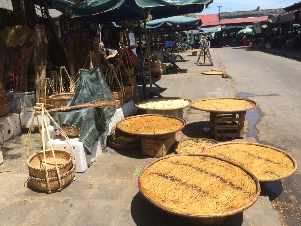 Drying the cao lau noodles in the sun