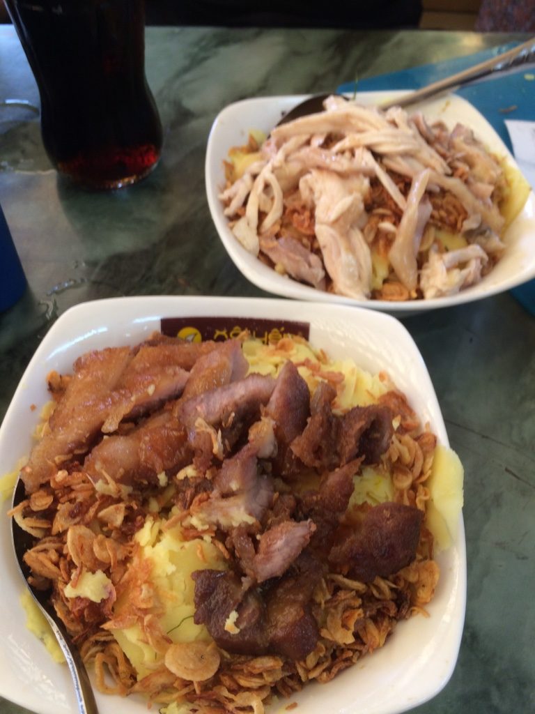 Tim's chicken rice bowl (40,000 VND = $2.30 CAD) and my pork rice bowl (30,000 VND = $1.75)