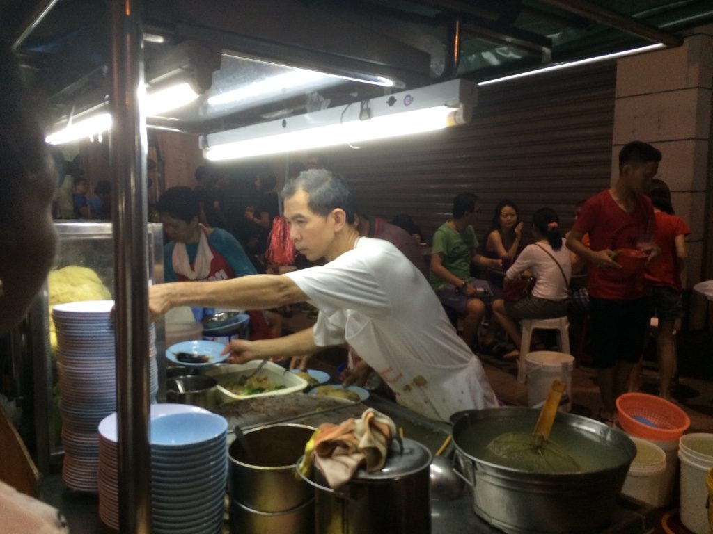 Standing here taking this picture was really hot. The steam from his stove was blasting out.